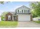 Charming two-story home with brick accents, attached two car garage, and a well-manicured lawn at 7541 Southern Lakes Dr, Indianapolis, IN 46237