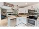 Modern kitchen with stainless steel appliances, white cabinetry, and stylish backsplash at 7541 Southern Lakes Dr, Indianapolis, IN 46237