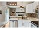 Well-lit kitchen featuring white cabinets, stainless steel appliances, and open layout at 7541 Southern Lakes Dr, Indianapolis, IN 46237