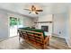 Spacious living room features a brick fireplace, sliding glass doors, and stylish light wood plank flooring at 7541 Southern Lakes Dr, Indianapolis, IN 46237