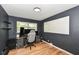 Spacious room with hardwood floors, featuring a work-from-home space and a large window at 7725 E 52Nd St, Indianapolis, IN 46226