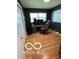 Bedroom with hardwood floors, large window, desk, and black accent wall at 7725 E 52Nd St, Indianapolis, IN 46226
