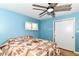 Bright bedroom features a ceiling fan, window with blinds, and a double door closet at 7725 E 52Nd St, Indianapolis, IN 46226