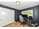 The room has natural light and hardwood floors, and it's set up as a functional workspace at 7725 E 52Nd St, Indianapolis, IN 46226