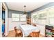 Bright dining area with hardwood floors and a view to the backyard at 7725 E 52Nd St, Indianapolis, IN 46226