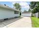 Home exterior features a spacious driveway leading to a detached two-car garage at 7725 E 52Nd St, Indianapolis, IN 46226