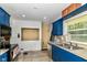 Efficient kitchen layout with blue cabinets and ample counter space at 7725 E 52Nd St, Indianapolis, IN 46226