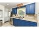 Functional kitchen with blue cabinetry and updated stainless steel appliances at 7725 E 52Nd St, Indianapolis, IN 46226
