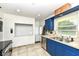 Well-lit kitchen featuring tiled flooring, stainless steel appliances and ample counter space at 7725 E 52Nd St, Indianapolis, IN 46226