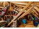 Finished attic with exposed beams, storage containers, and golf clubs at 8088 Lantern Ln, Pendleton, IN 46064