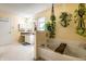 Cozy bathroom features a soaking tub, vanity with sink, and cheerful plant accents at 8088 Lantern Ln, Pendleton, IN 46064