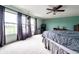 Bright, spacious bedroom with a ceiling fan, large windows, carpet, and ample furniture space at 8088 Lantern Ln, Pendleton, IN 46064