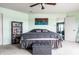 Relaxing bedroom with ceiling fan, soft carpet, and a gray upholstered storage bench at the foot of the bed at 8088 Lantern Ln, Pendleton, IN 46064
