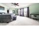 Light-filled bedroom features a ceiling fan, carpet, and serene views from the double window at 8088 Lantern Ln, Pendleton, IN 46064