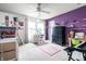 Stylish bedroom featuring a white desk, purple accent wall, and soft natural light at 8088 Lantern Ln, Pendleton, IN 46064