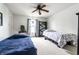 Bedroom features two beds, neutral paint, ceiling fan, and large windows at 8088 Lantern Ln, Pendleton, IN 46064