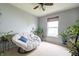 Bright bedroom featuring a comfortable papasan chair, neutral walls, and large window with an abundance of plants at 8088 Lantern Ln, Pendleton, IN 46064