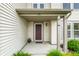 Cozy front porch with a classic door and well-manicured plants, creating a warm welcome at 8088 Lantern Ln, Pendleton, IN 46064