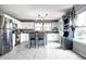 Well-lit kitchen with white cabinets, stainless steel appliances, and a central island with seating at 8088 Lantern Ln, Pendleton, IN 46064