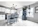 Bright kitchen with modern white cabinetry, granite counters, and a breakfast bar with two bar stools at 8088 Lantern Ln, Pendleton, IN 46064
