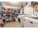Efficient laundry room with washer, dryer, and ample shelving filled with various supplies for organization and convenience at 8088 Lantern Ln, Pendleton, IN 46064