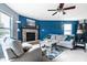 Inviting living room with stone fireplace, comfortable sofas, and ample natural light at 8088 Lantern Ln, Pendleton, IN 46064