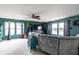 Open living room area showcasing large windows, neutral carpets, modern furniture, and an exterior view at 8088 Lantern Ln, Pendleton, IN 46064