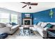 Cozy living room with a stone fireplace, plush sofas, a patterned rug, and vibrant wall accents at 8088 Lantern Ln, Pendleton, IN 46064