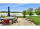 Backyard patio with lake view, outdoor dining set, and inviting seating arrangements for relaxation and entertaining at 8088 Lantern Ln, Pendleton, IN 46064