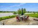 Backyard patio with lake view, outdoor dining set, and inviting seating arrangements for relaxation and entertaining at 8088 Lantern Ln, Pendleton, IN 46064