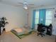 A bright bedroom with a cozy bed, a desk, and blue curtains, creating a relaxing space for rest and study at 8165 Amarillo Dr, Indianapolis, IN 46237
