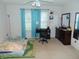 A bright bedroom with a cozy bed, a desk, and blue curtains, creating a relaxing space for rest and study at 8165 Amarillo Dr, Indianapolis, IN 46237