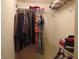 This closet features a variety of clothes hanging on rods, and folded on shelves at 8165 Amarillo Dr, Indianapolis, IN 46237