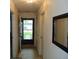 Inviting entryway with neutral walls, a large mirror, and a view of the front door leading outside at 8165 Amarillo Dr, Indianapolis, IN 46237