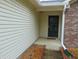 A detailed shot of the front door and surrounding vinyl siding, highlighting the well-maintained exterior at 8165 Amarillo Dr, Indianapolis, IN 46237