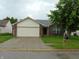 Charming single-Gathering home featuring brick and vinyl siding, a two-car garage, and mature landscaping at 8165 Amarillo Dr, Indianapolis, IN 46237