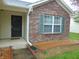 Close-up of the front entryway showcasing the brick facade, front window, and decorative shutters at 8165 Amarillo Dr, Indianapolis, IN 46237
