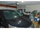 This garage features a dark-colored car in front of organized racks and boxes at 8165 Amarillo Dr, Indianapolis, IN 46237