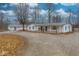 Charming single-story home with a covered porch, gravel driveway, and ample parking at 8230 W Pocket Hollow Rd, Gosport, IN 47433