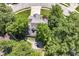 Aerial view of a property showcasing the house nestled among mature trees and landscaping at 8530 Ardennes Dr, Fishers, IN 46038