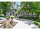 Spacious backyard featuring a large wooden deck, surrounded by lush greenery and mature trees at 8530 Ardennes Dr, Fishers, IN 46038