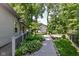 Beautifully landscaped backyard with wooden walkway leading to a deck and lush greenery at 8530 Ardennes Dr, Fishers, IN 46038