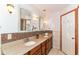 Well-lit bathroom featuring double sinks, granite counters, and updated fixtures at 8530 Ardennes Dr, Fishers, IN 46038