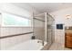 Bright bathroom with tub and shower, neutral tiling, and natural light from a window at 8530 Ardennes Dr, Fishers, IN 46038