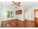 Bedroom with hardwood floors, ceiling fan, and built-in storage above the window at 8530 Ardennes Dr, Fishers, IN 46038