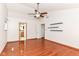 Large primary bedroom featuring hardwood floors, modern ceiling fan, and access to an ensuite bathroom at 8530 Ardennes Dr, Fishers, IN 46038