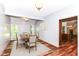 Bright dining room featuring a wood table with seating for four, bathed in natural light from two large windows at 8530 Ardennes Dr, Fishers, IN 46038