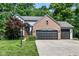 Charming two-story home showcasing a brick facade, two-car garage, and a well-manicured front lawn at 8530 Ardennes Dr, Fishers, IN 46038