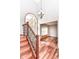 Inviting foyer featuring hardwood floors, staircase with iron railings, and a view into the living room at 8530 Ardennes Dr, Fishers, IN 46038