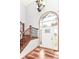 Bright foyer with hardwood floors, staircase, and a grand window above the front door at 8530 Ardennes Dr, Fishers, IN 46038